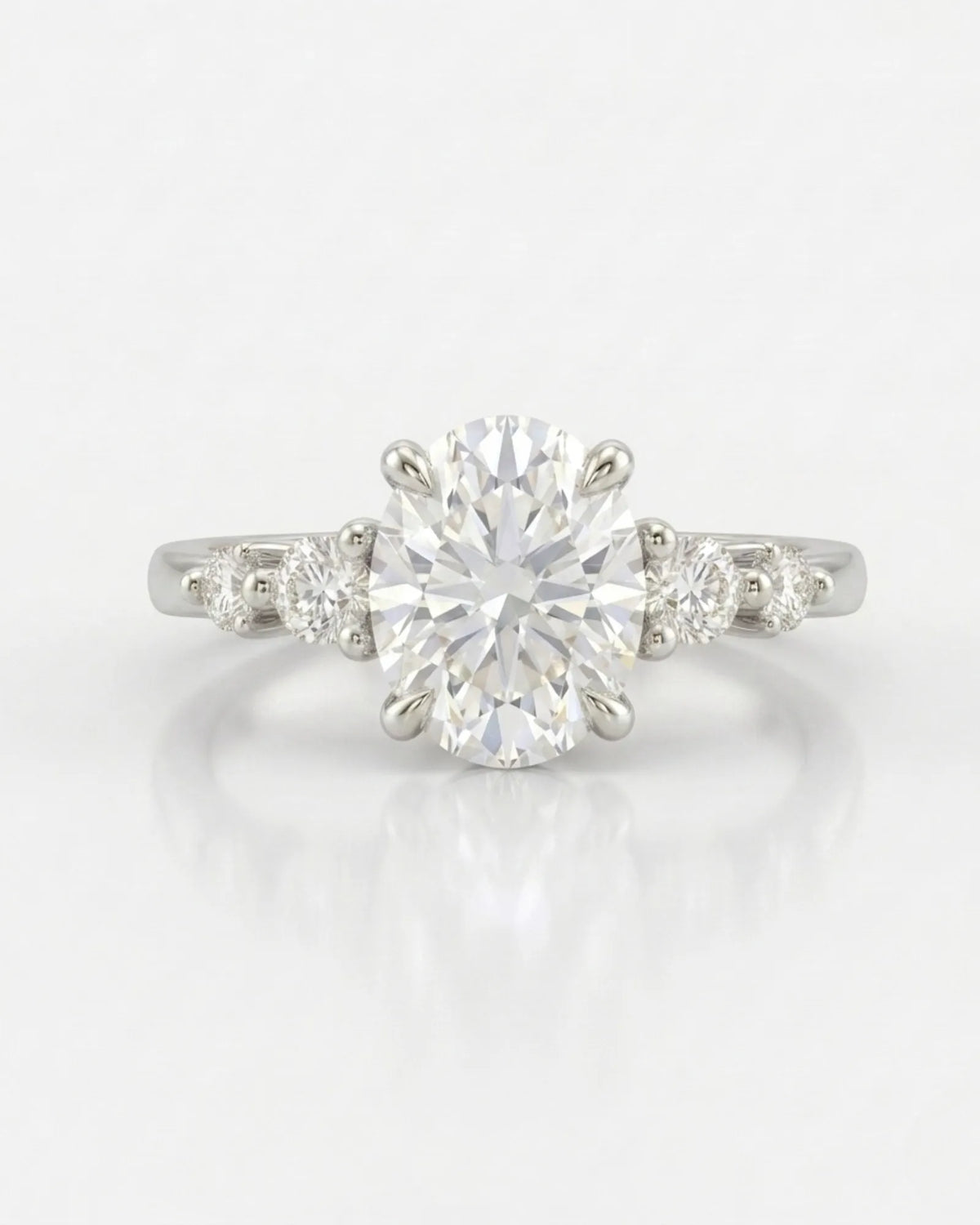 Oval five stone moissanite engagement ring for a refined proposal crafted in platinum | SARATTI