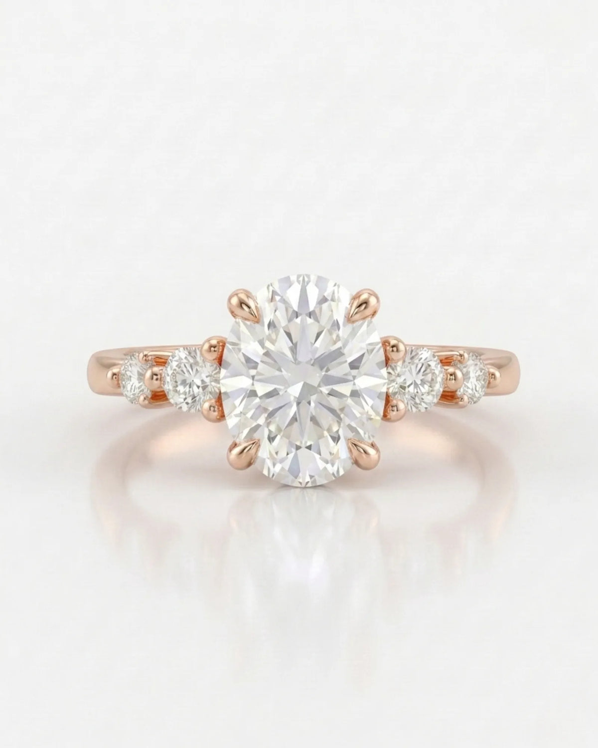 Oval five stone moissanite engagement ring for a romantic proposal in 18K rose gold | SARATTI