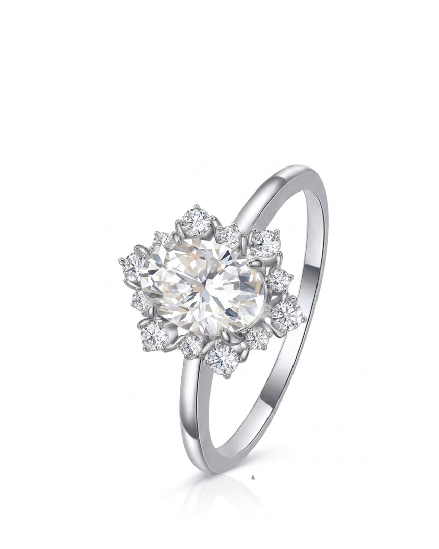 Oval moissanite engagement ring with floral halo and round accents crafted in platinum | SARATTI
