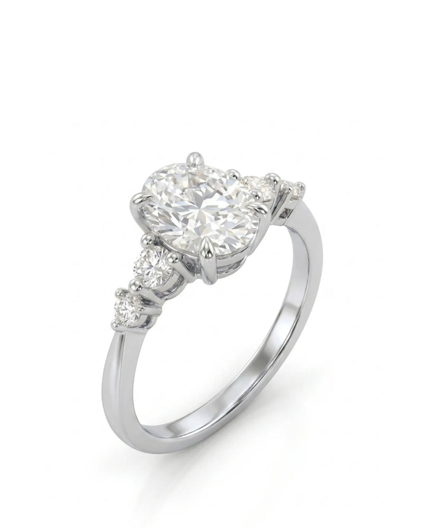 Oval moissanite engagement ring with graduated round side stones in 18K white gold | SARATTI