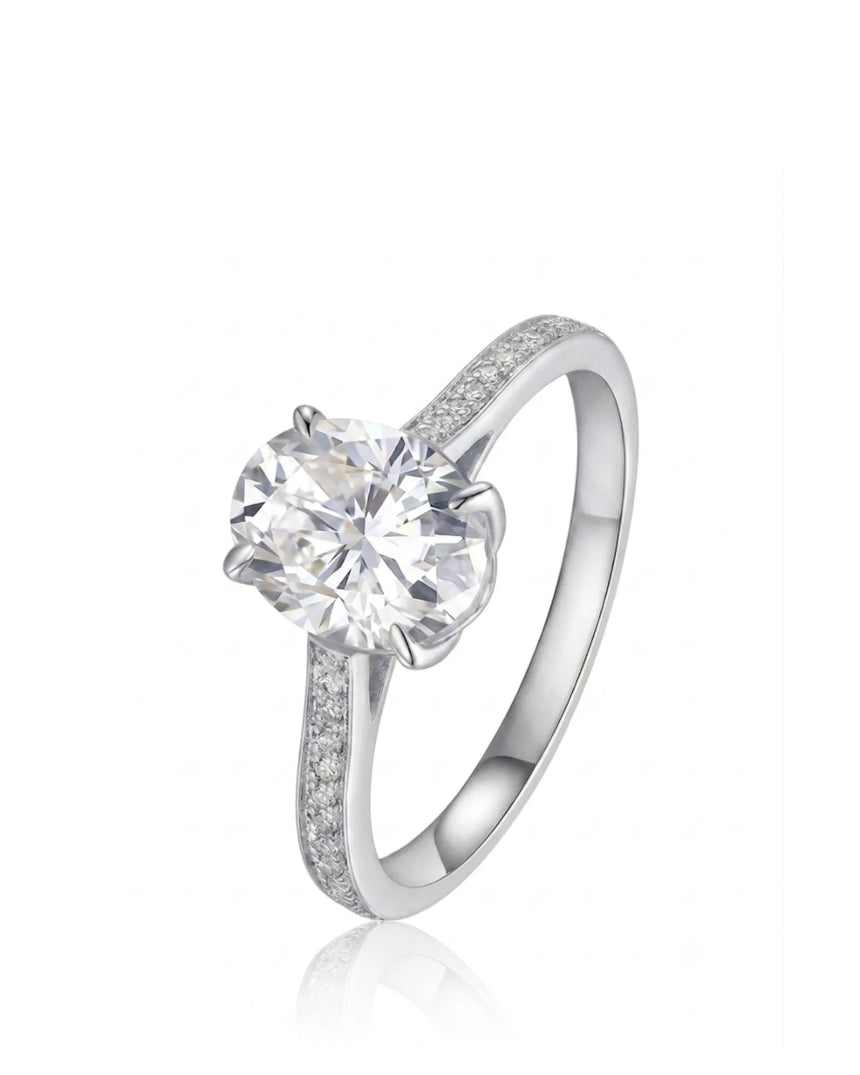 Oval moissanite engagement ring with pavé round side stones in 18K white gold | SARATTI