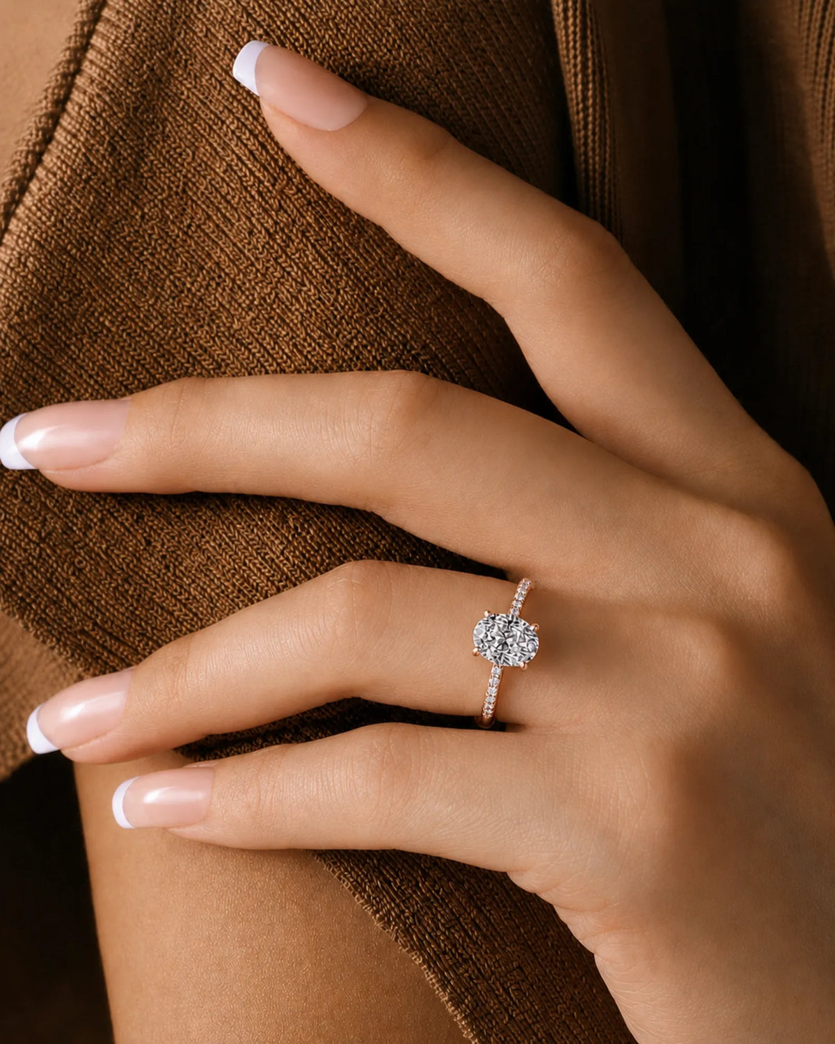 Oval moissanite ring in rose gold with four-prong setting and concealed halo | SARATTI.