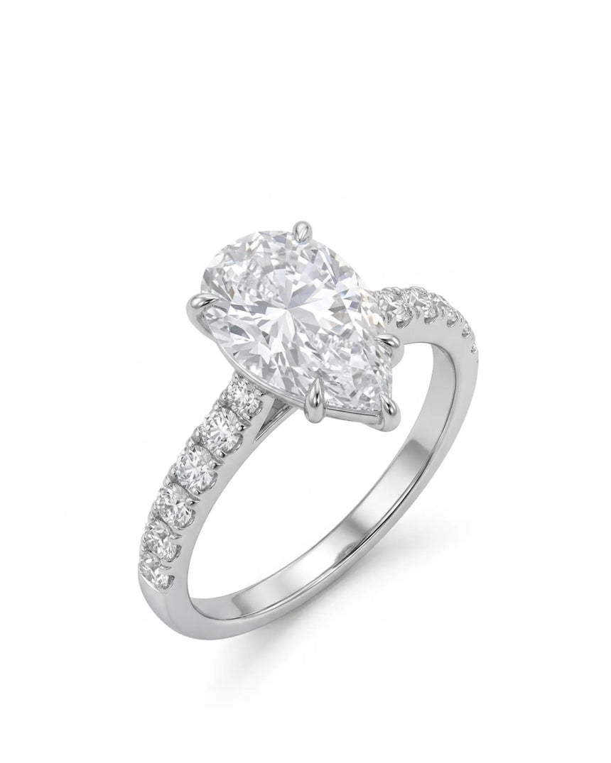 Pear cut moissanite engagement ring with scallop-set round side stones in 18K white gold | SARATTI