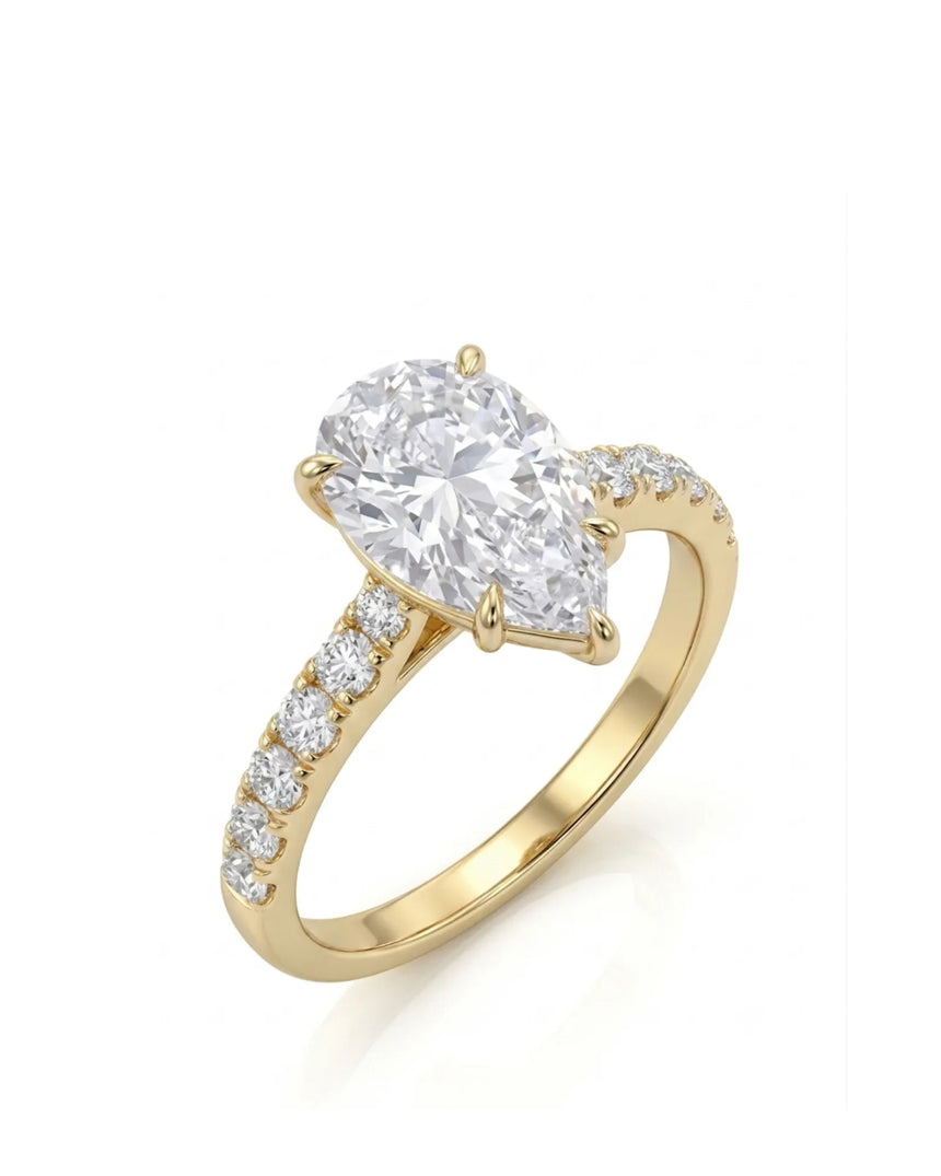 Pear cut moissanite engagement ring with scallop-set round side stones in 18K yellow gold | SARATTI