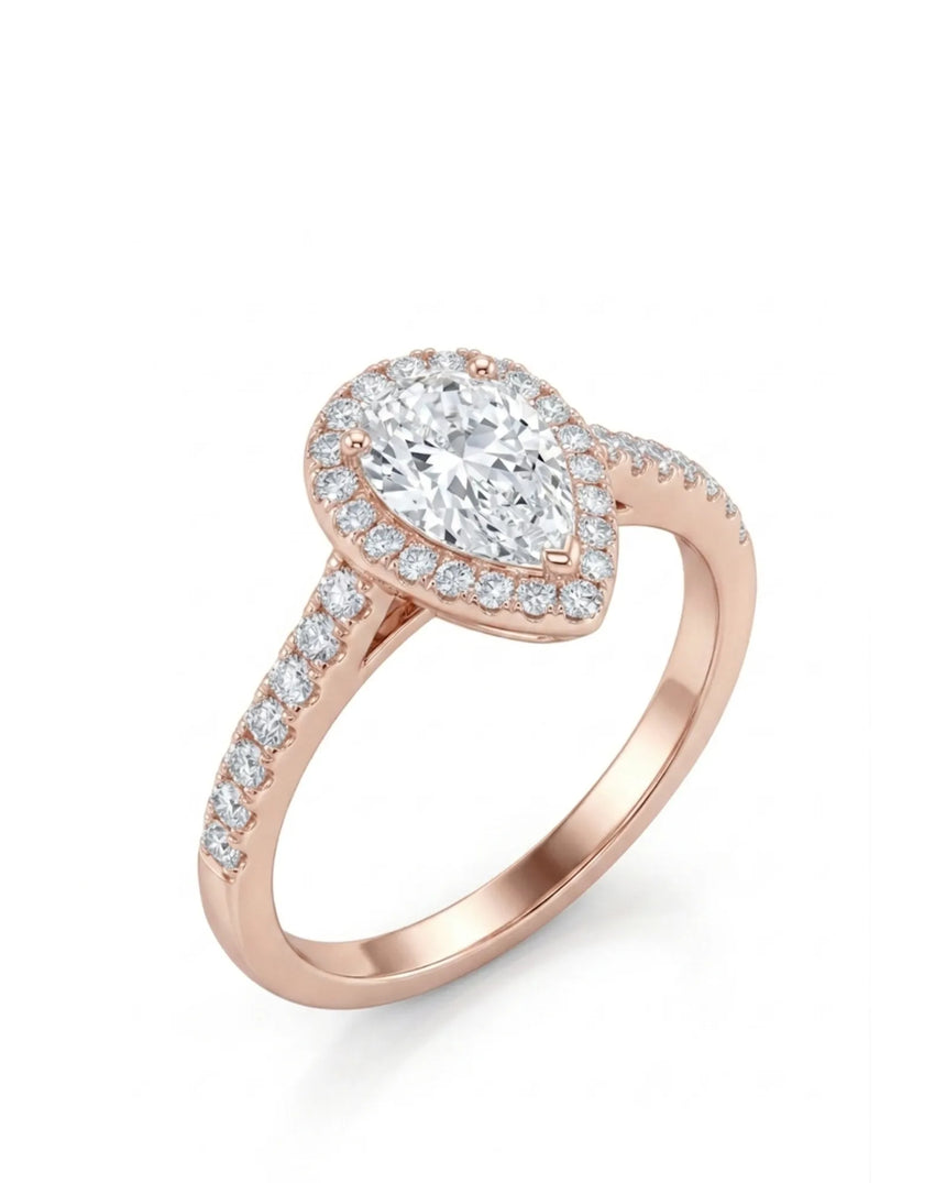 Pear shaped moissanite engagement ring with round halo and pavé shoulders in 18K rose gold | SARATTI
