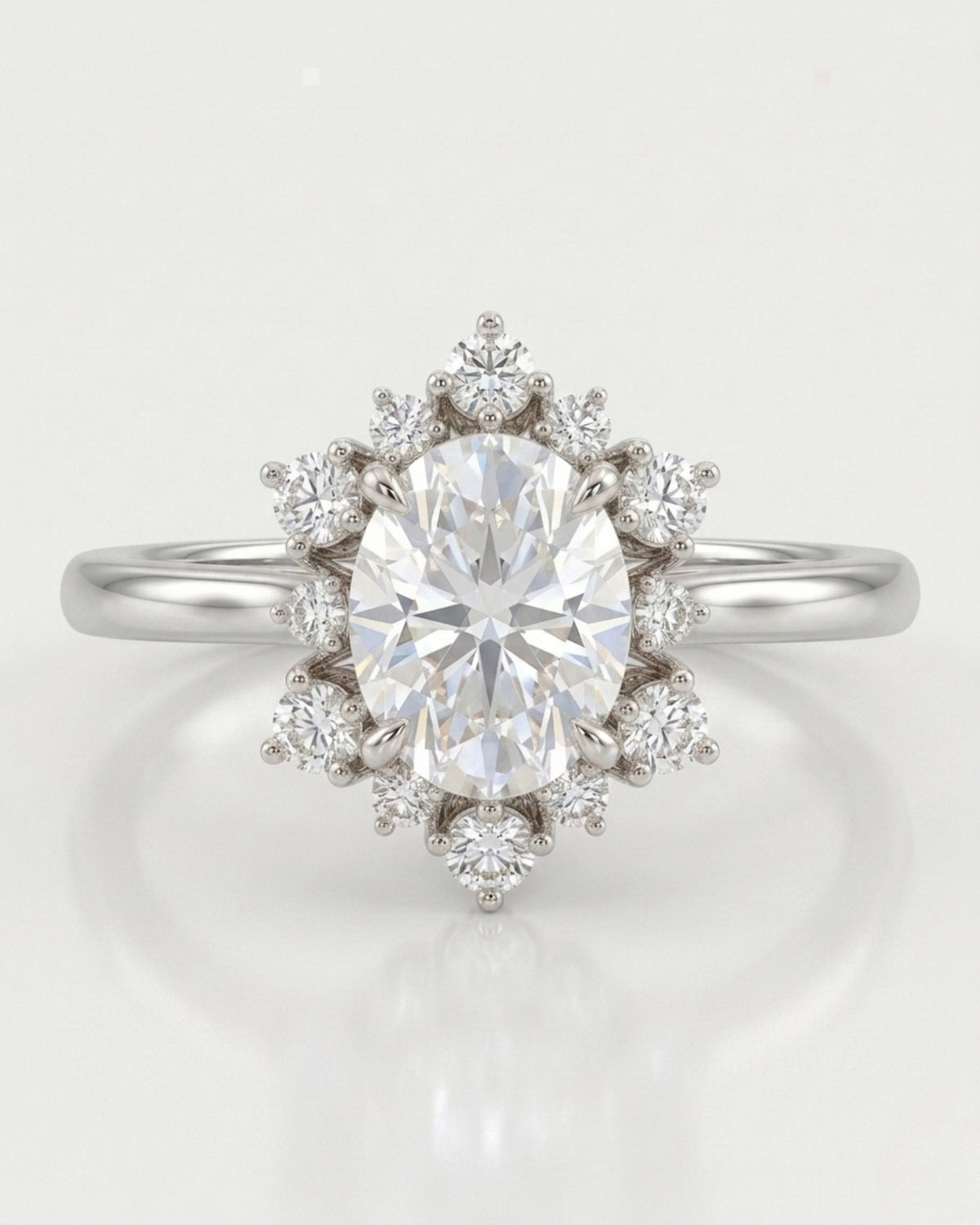 Romantic floral moissanite ring with oval center and crown-like halo in polished platinum | SARATTI