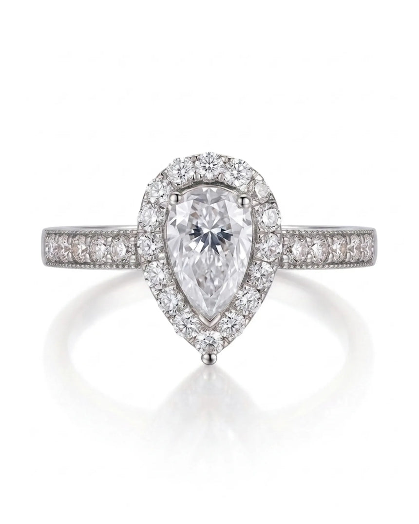 Romantic pear shaped moissanite ring with teardrop halo and pavé shoulders in platinum | SARATTI