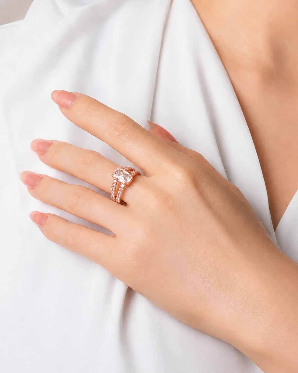 Rose gold emerald-cut moissanite engagement ring with pavé split shank and four-prong setting | SARATTI.