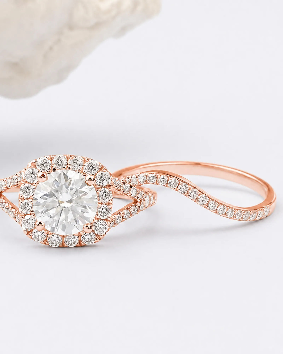 Rose gold split shank moissanite ring set with halo center and pavé accents across both rings | SARATTI