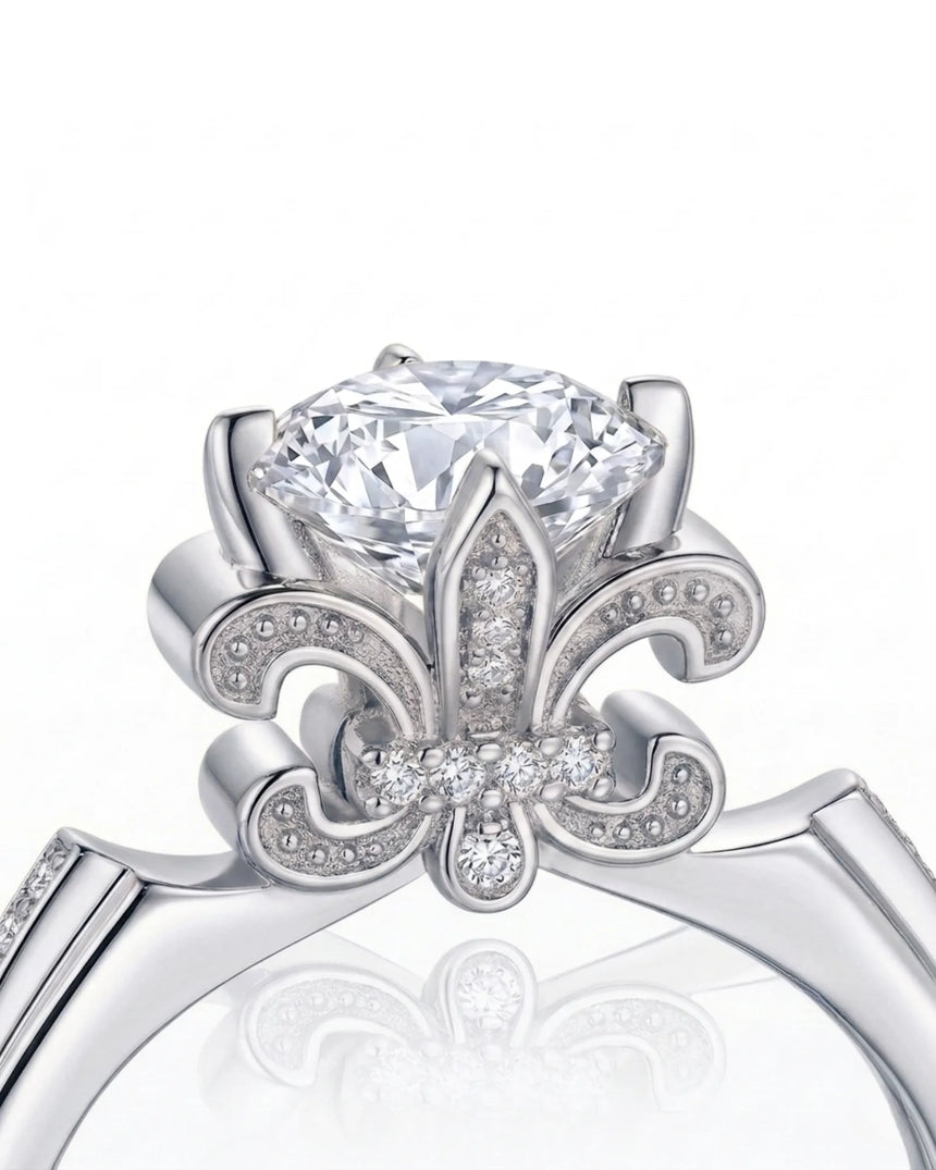 Round moissanite proposal ring with pavé side stones and symbolic fleur-de-lis setting in 18K white gold | SARATTI