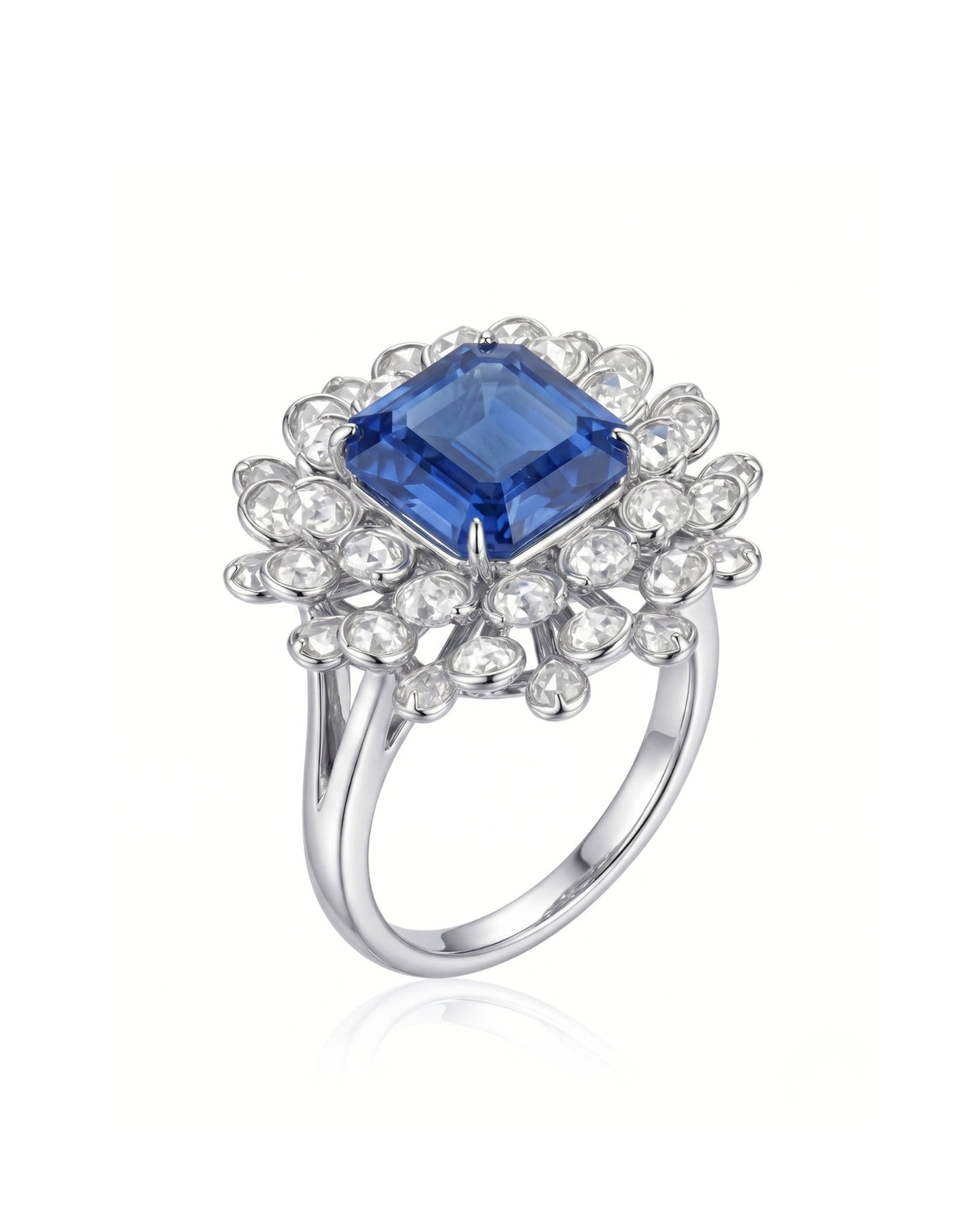 Royal blue sapphire ring with emerald-cut center and diamond floral halo in 18K white gold | SARATTI