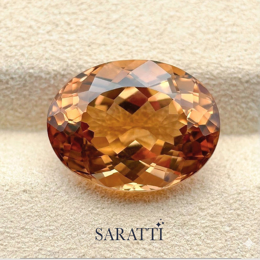 Side profile of 13.65 carat Imperial Topaz oval gemstone | SARATTI