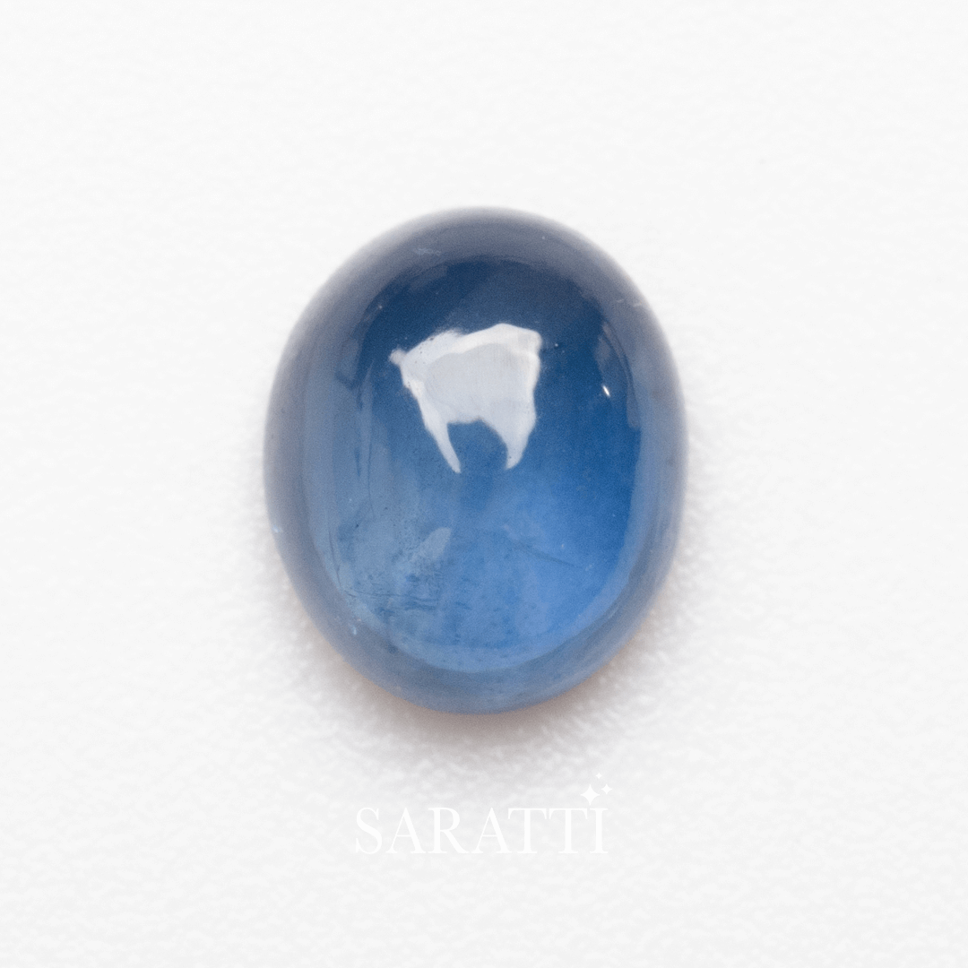 Side profile of oval cabochon sapphire gemstone highlighting luster | SARATTI