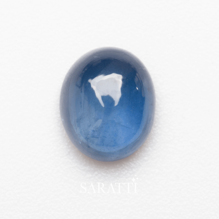 Side profile of oval cabochon sapphire gemstone highlighting luster | SARATTI