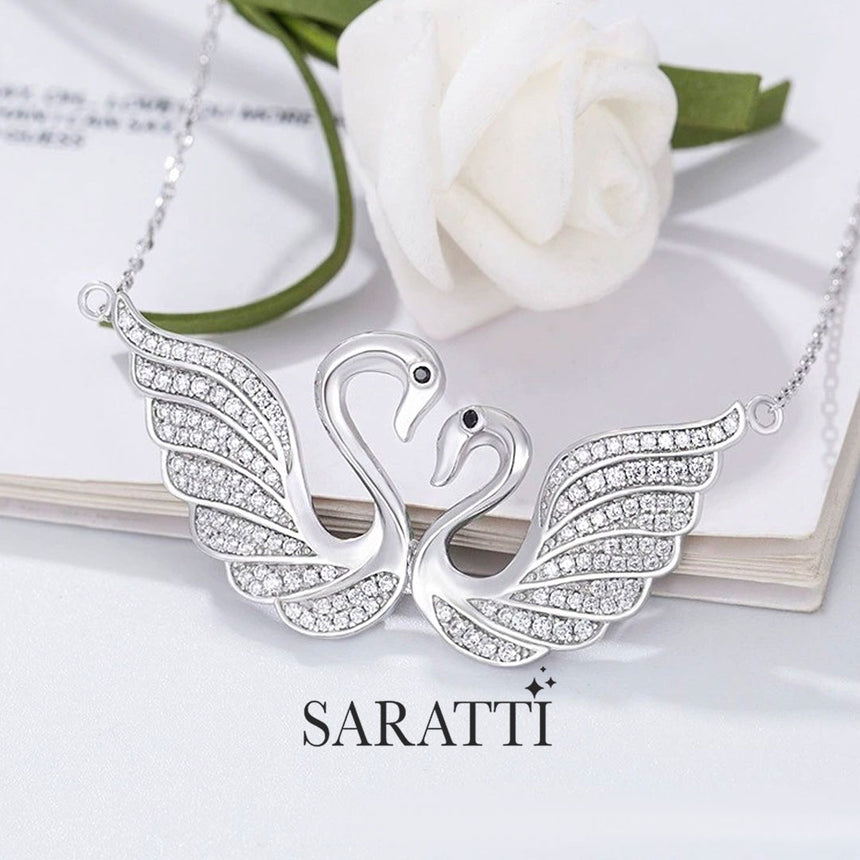 Close up shot of the pendant of the  Twin Silver Swans Pendant Necklace | Saratti