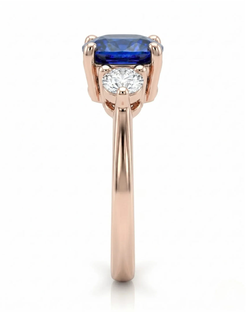 Three stone sapphire ring with round diamond accents in romantic rose gold | SARATTI