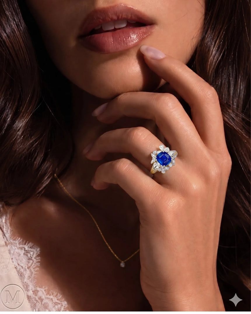 Unheated royal blue sapphire ring framed by bright diamonds in 18K yellow gold | SARATTI