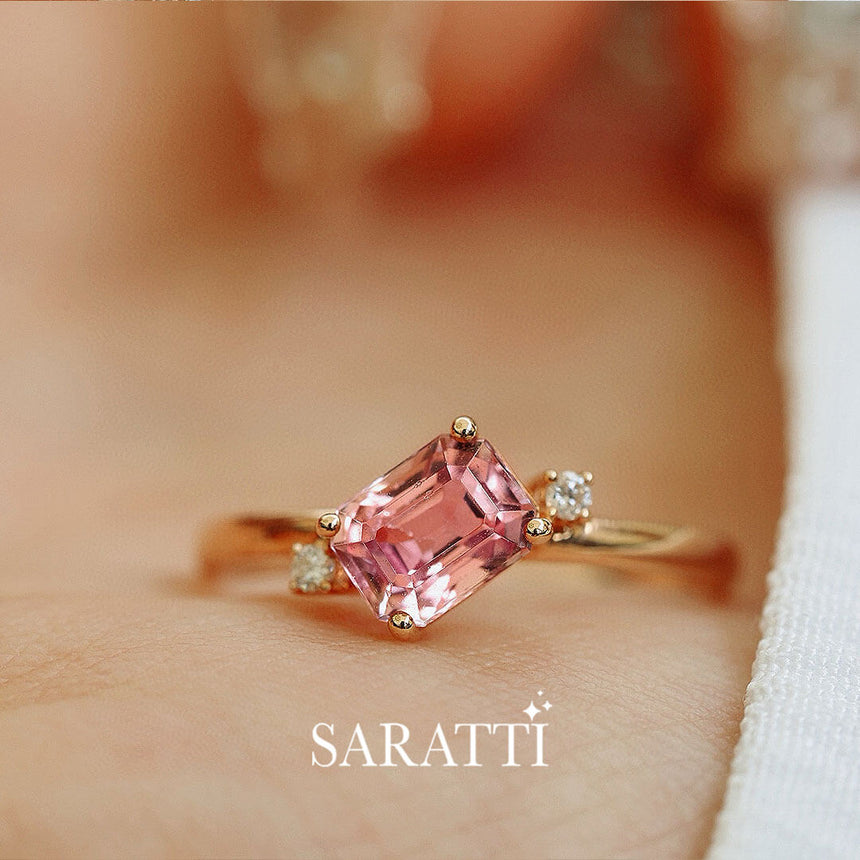 Pink Emerald Cut Tourmaline in focus | Model holds the Sakura Trilogy Tourmaline and Diamond Ring | Saratti Fine Jewelry