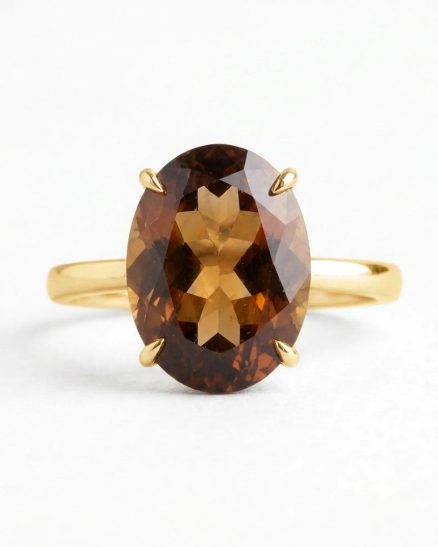 Warm Imperial Topaz engagement ring featuring an oval center and refined 18K yellow gold band | SARATTI