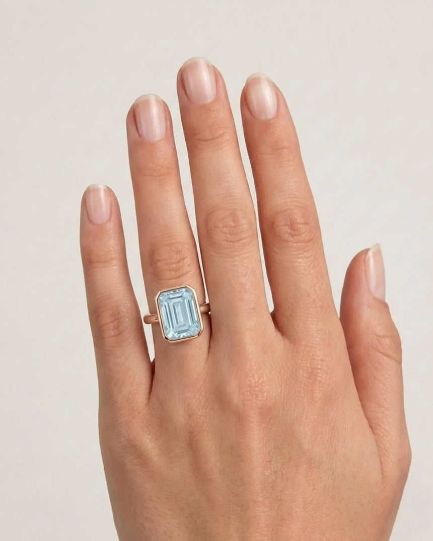 AUREX emerald cut Aquamarine bezel ring setting in Rose Gold, shown on hand | SARATTI