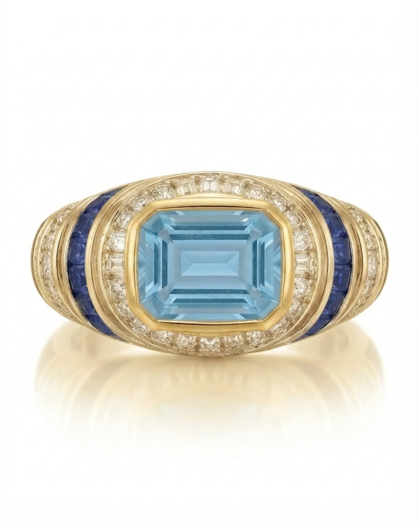 Azzurro Regent emerald-cut Aquamarine cocktail ring setting in yellow gold, front view with baguette diamond frame and blue sapphire channels | SARATTI