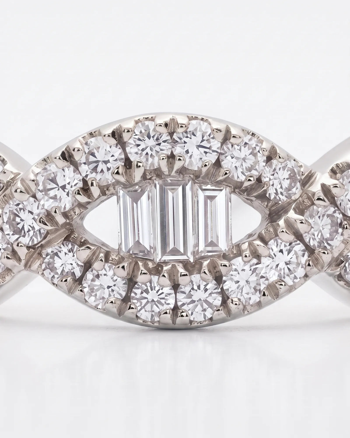 Platinum wedding ring with baguette and round brilliant diamonds across the upper band | SARATTI