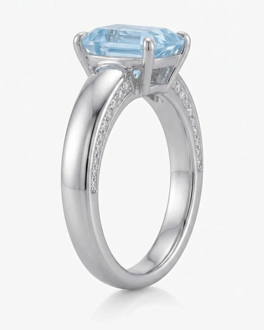 Céleste Arc emerald cut Aquamarine four-prong ring setting in white gold, front view | SARATTI