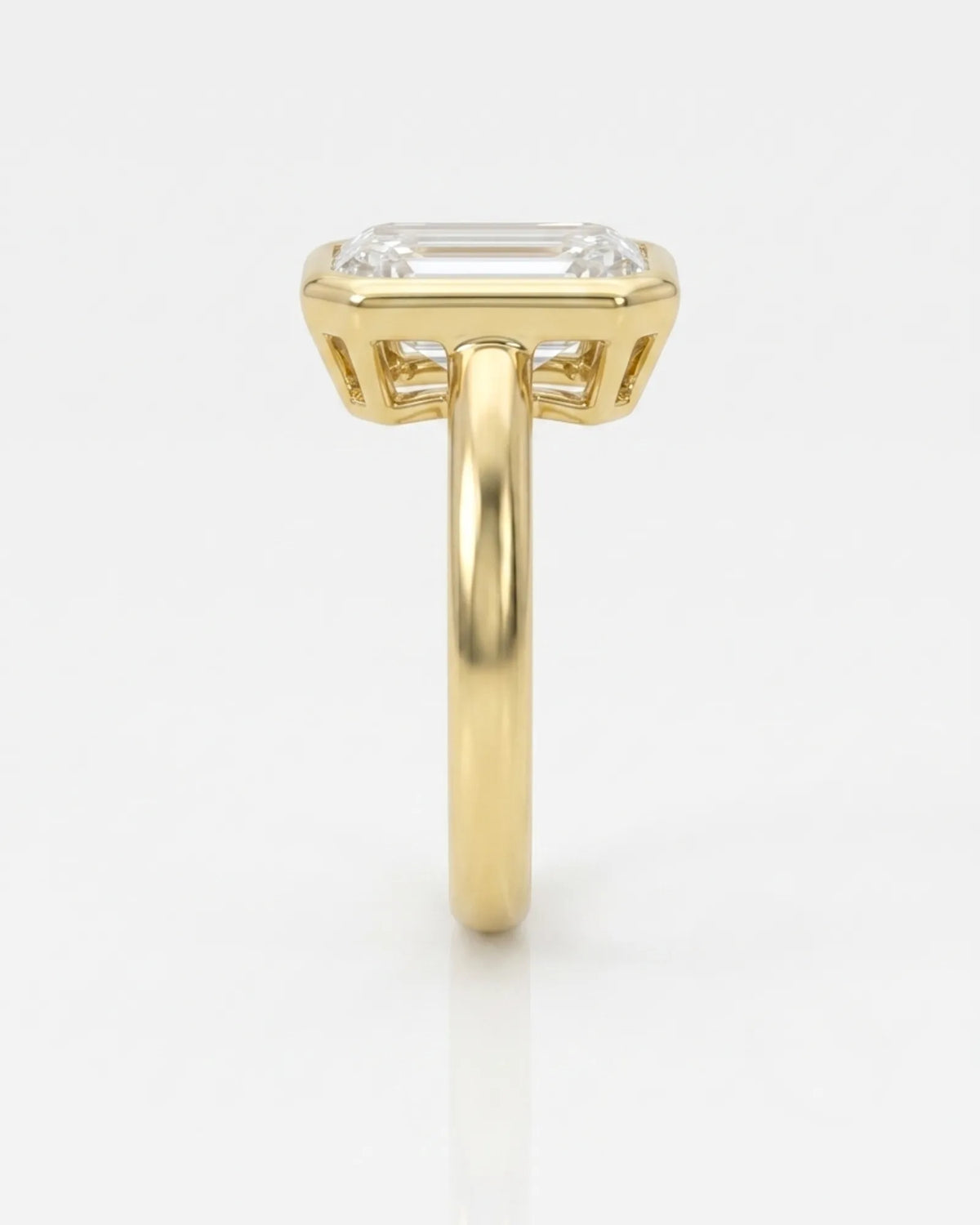 Golden Horizon natural emerald cut diamond bezel engagement ring in yellow gold side profile | SARATTI