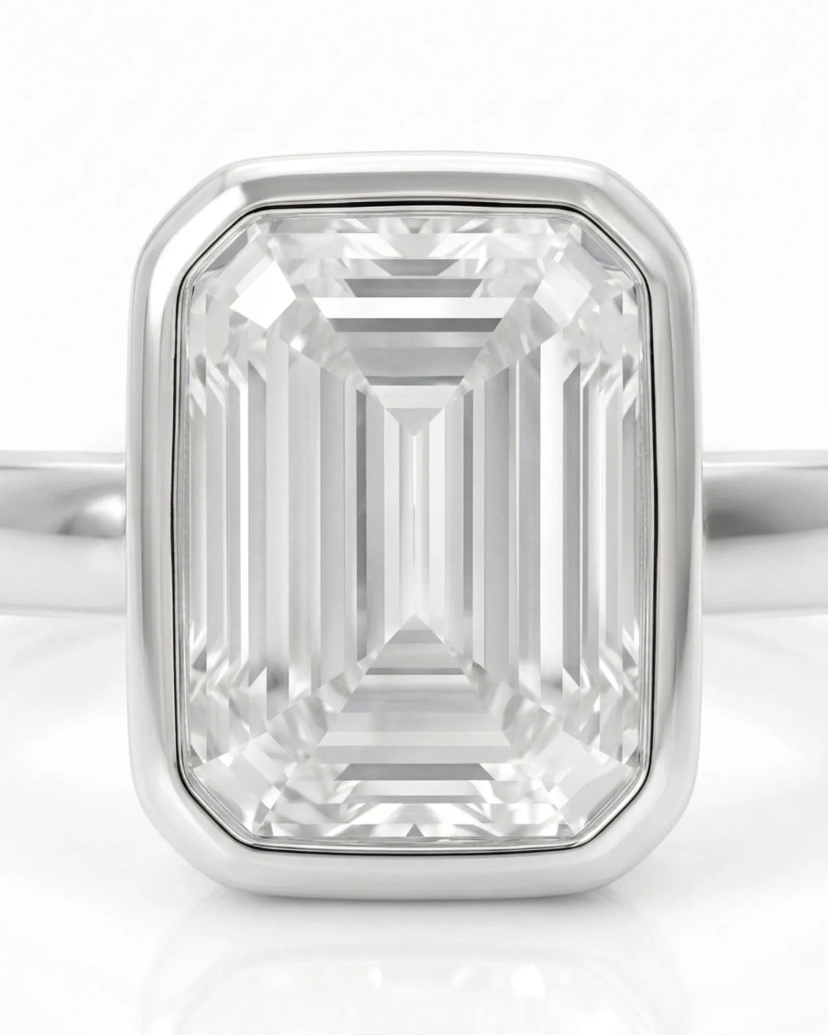 Natural emerald cut diamond full bezel ring in white gold close-up | SARATTI