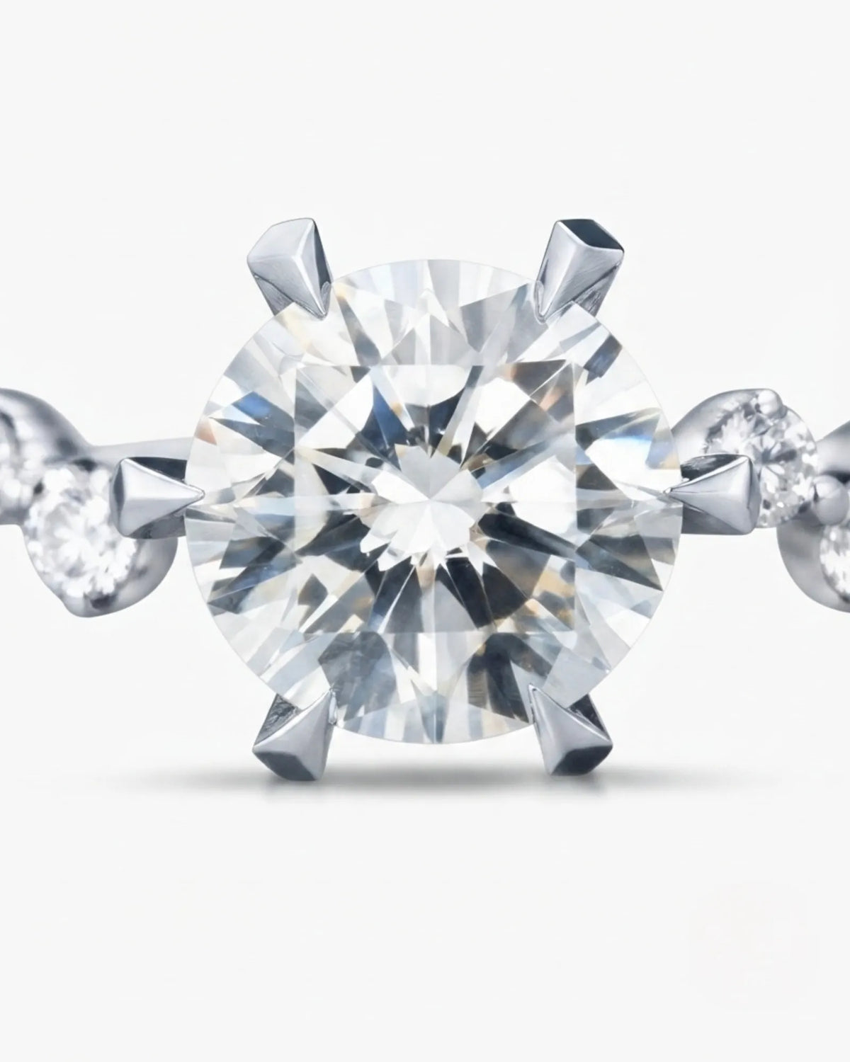 Joan 1 carat round natural diamond six-prong engagement ring in platinum, macro detail of graduated round brilliant diamond side stones | SARATTI