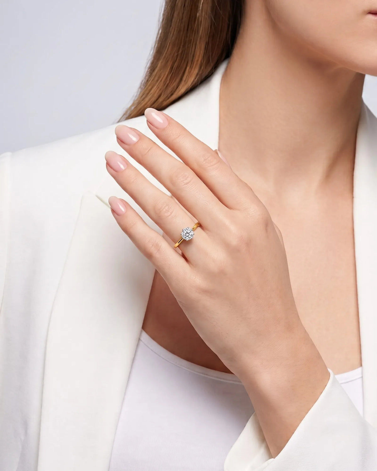 KATYA 1 carat round natural diamond heart-prong solitaire ring in 18K yellow gold, worn on hand | SARATTI