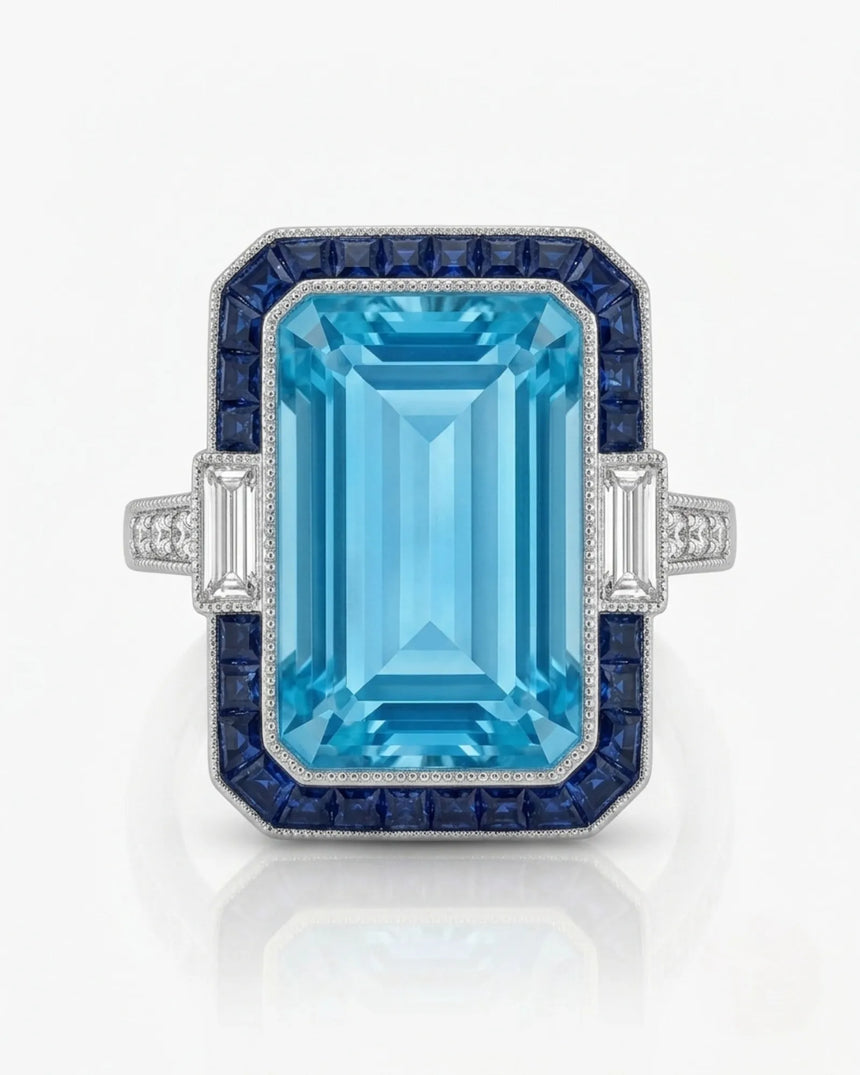Saphira Line emerald-cut Aquamarine ring setting in white gold, front view with blue sapphire halo and baguette side diamonds | SARATTI