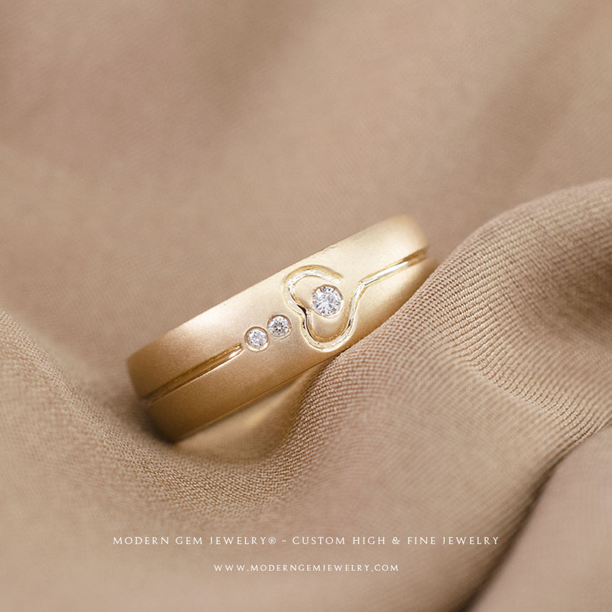 Art Deco Wedding Band in Yellow Gold with Three Natural Diamonds on Brown Silk Sheet | Modern Gem Jewelry | Saratti
