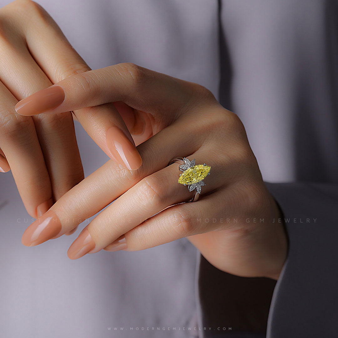 2 carat Marquise Fancy Yellow Diamond Ring with Colorless Diamond Accents on Woman's Finger | High End Diamond Engagement Ring | Modern Gem Jewelry | Saratti