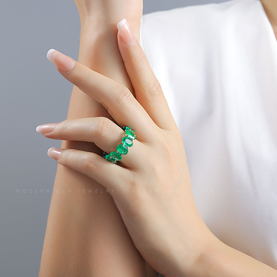 Oval Emerald Band Ring in Yellow Gold | Custom Emerald High Jewelry Ring on Woman's Finger | Modern Gem Jewelry