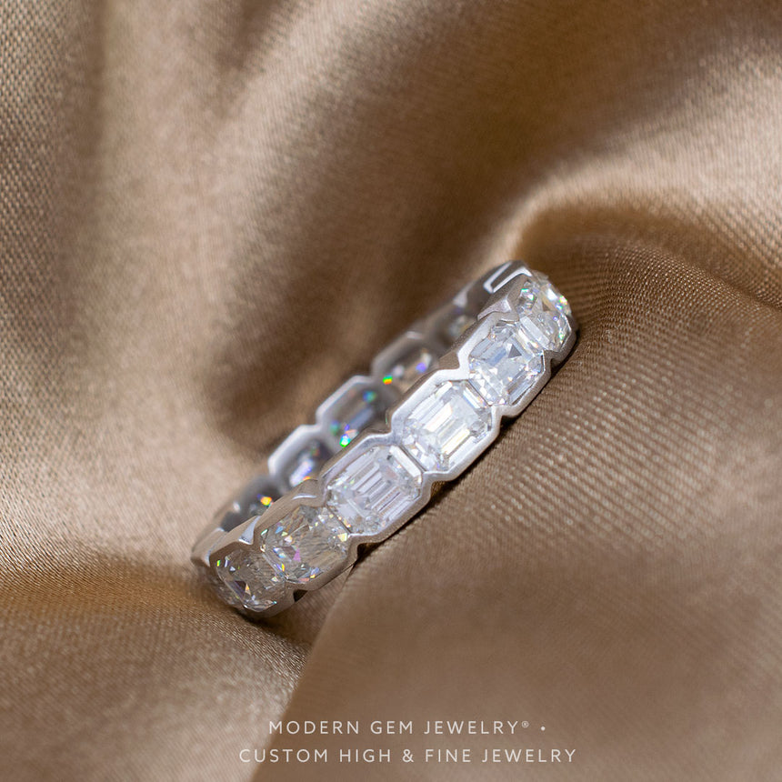 Bezel Set Wedding Band For Emerald Cut Engagement Ring in White Gold on Silk Sheets | Modern Gem Jewelry | Saratti