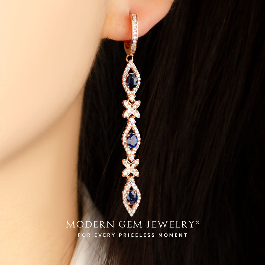 model wears clover motif natural sapphire and diamond pave drop earrings