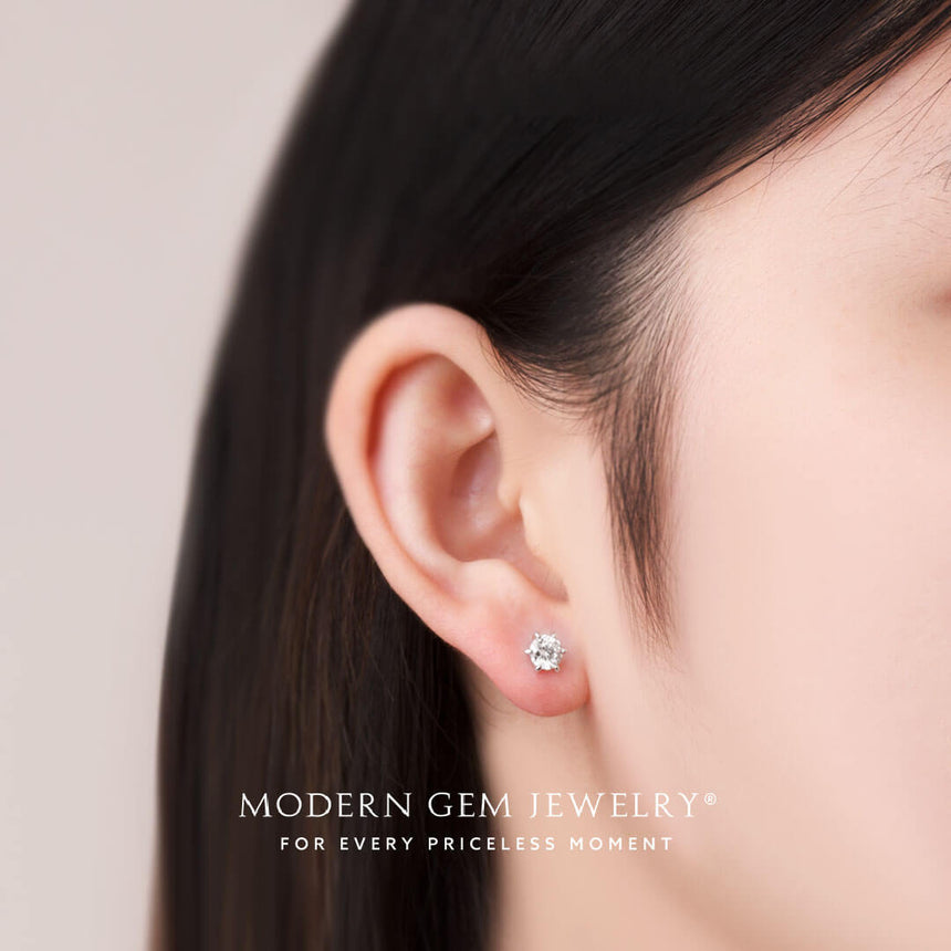 Model wears prong set diamond stud earring