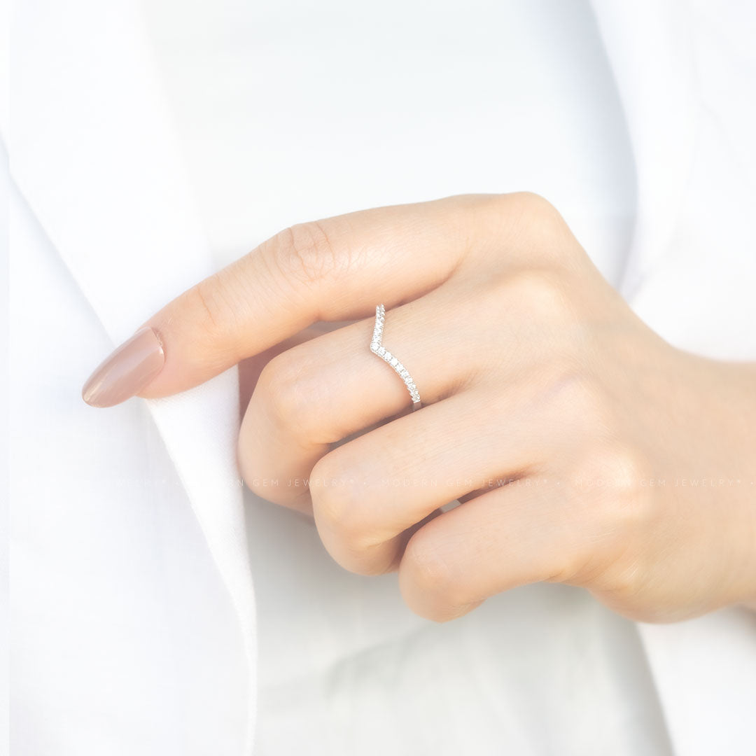 Curved pave diamond wedding band in 18K white gold worn on hand | SARATTI