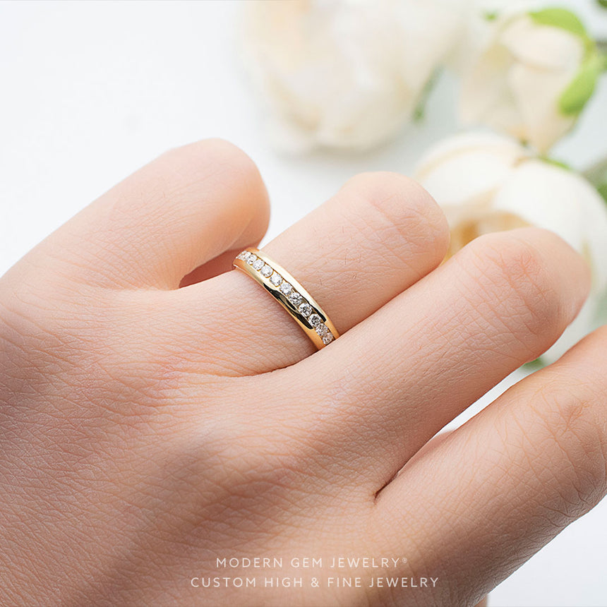 Channel Set Diamond Wedding Band in Yellow Gold on Female Finger | Modern Gem Jewelry | Saratti