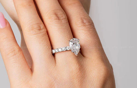 Pear Cut Diamond Engagement Ring with Diamond Accents on Model's Finger | Saratti 