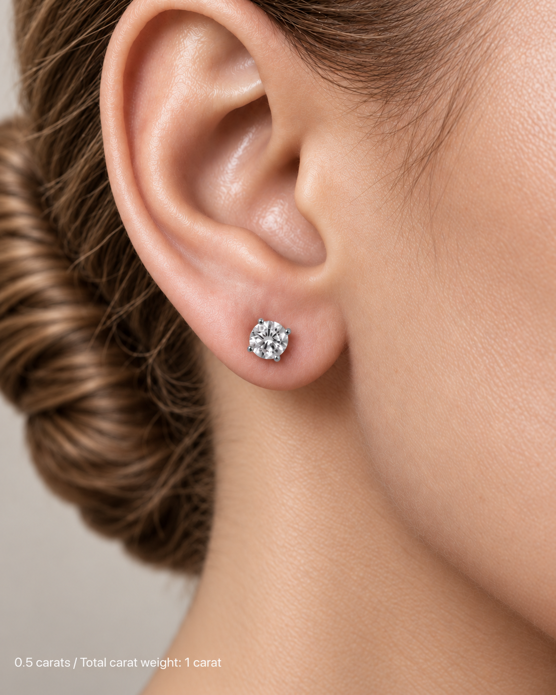 1.00 ct. tw. lab-grown round diamond studs in 18K white gold, fair skin on-ear model | SARATTI
