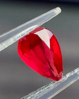 Alternate view of 0.75 CTS Natural vivid red Ruby pear showing pointed outline and facet reflections | SARATTI