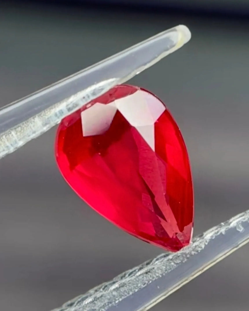 0.75 CTS Natural vivid red Ruby pear main view showing elongated modified brilliant faceting | SARATTI