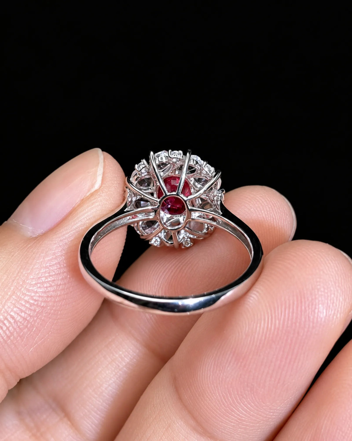 1.02ct oval ruby ring surrounded by white sapphire petals and diamond accents in 18K white gold -- SARATTI