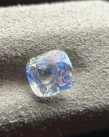 Natural Rainbow Moonstone cushion alternate face-up view with blue and softer violet reflections through the facets | SARATTI