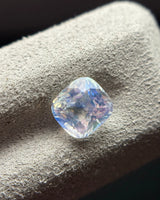 Natural Rainbow Moonstone cushion face-up view showing its near-square outline and blue-dominant optical appearance | SARATTI