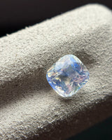Natural Rainbow Moonstone cushion side-angled view showing rounded cushion proportions, facets and cool blue reflections | SARATTI