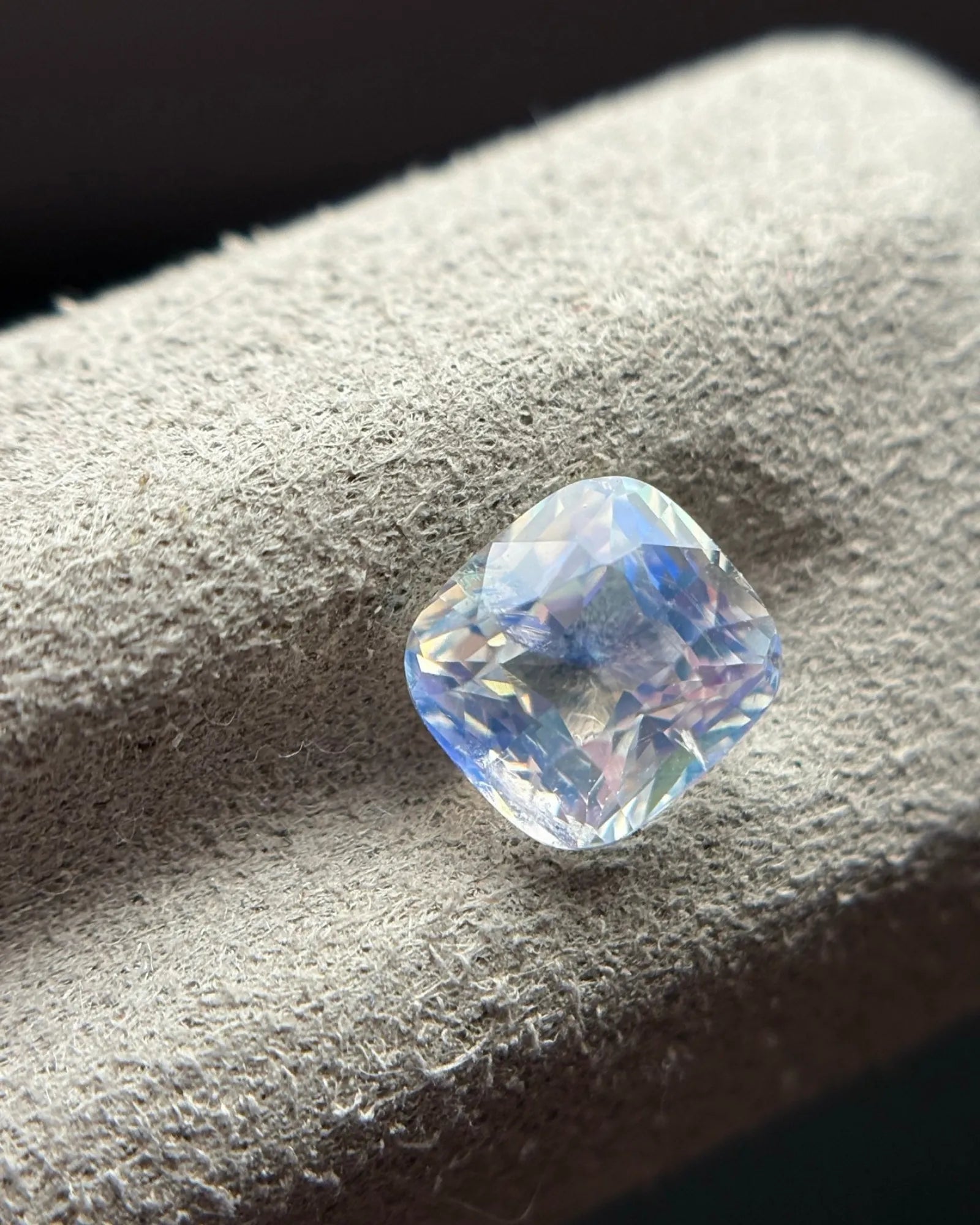 Natural Rainbow Moonstone cushion side-angled view showing rounded cushion proportions, facets and cool blue reflections | SARATTI