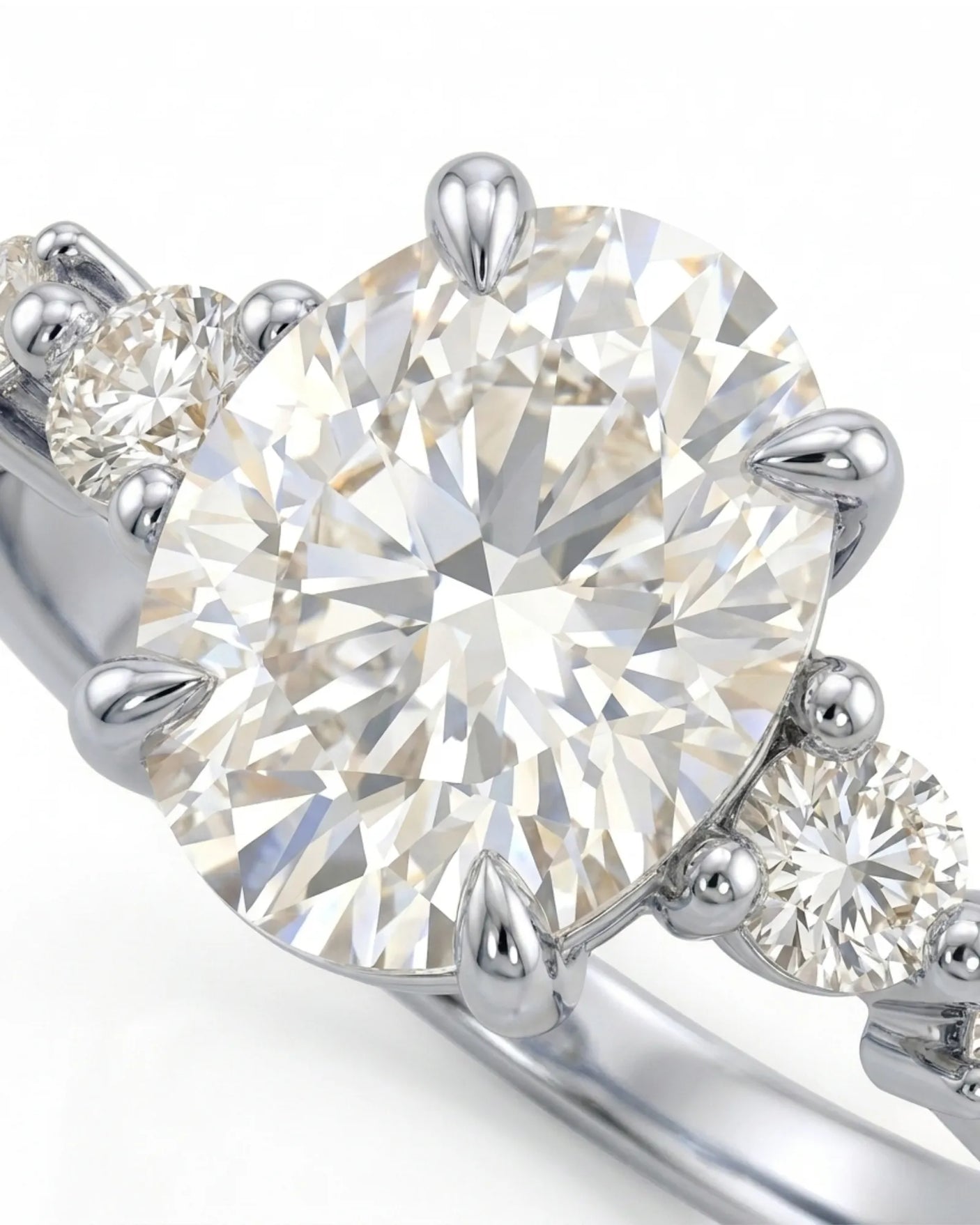 Luxury oval diamond ring with graduated side stones and bespoke 18K white gold craftsmanship | SARATTI